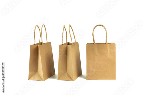 Mockup buff paper carry bags isolated on white. Delivery service of goods and grocery, shopping courier. Environment and eco friendly packaging, plastic free takeaway
