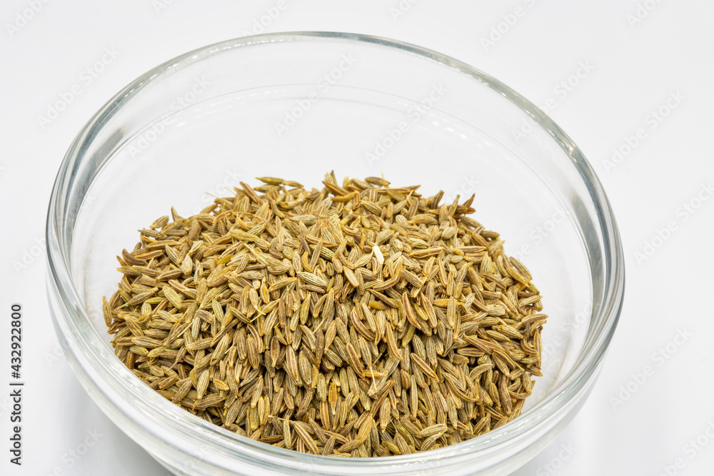zira spice seasoning in a glass bowl closeup against white