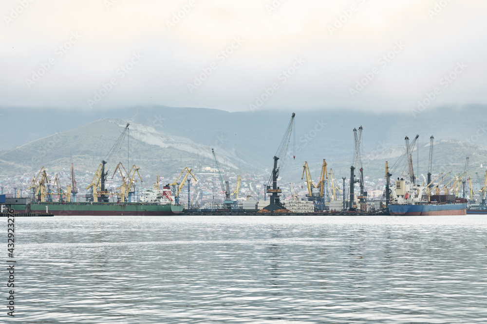  General view of the water area of the sea cargo port in rainy weather. Copy space.
