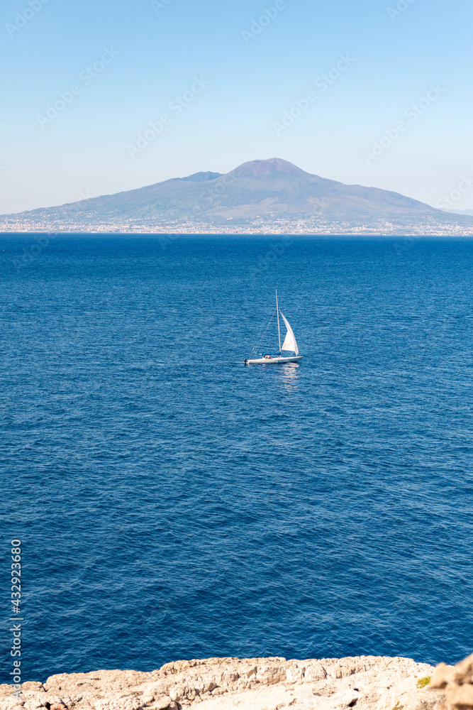 SAILBOAT in the sea of Sorrento with Vesuvius in the distance, Naples, Italy