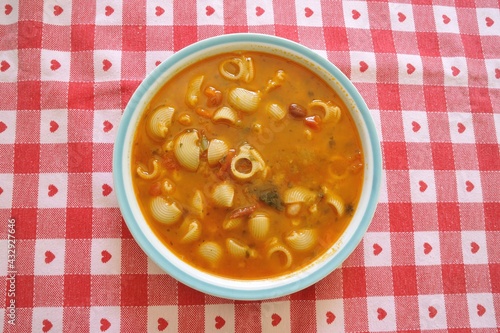 Italian minestrone dish typical of healthy and healthy Italian cuisine with vegetables, beans, potatoes, peas, pasta