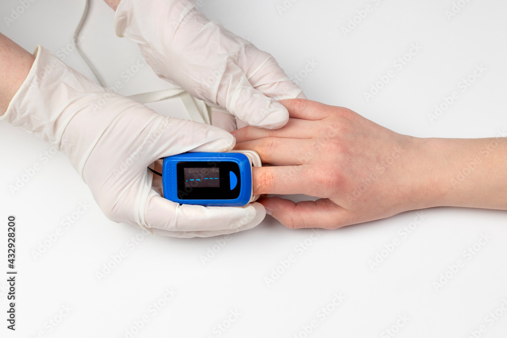 Doctor hand in white medical latex gloves hold patients hand with pulse oximetry on the finger. Noninvasive and painless oxygen saturation level test. Part of set. Doctor hand in white medical latex gloves hold patients hand with pulse oximetry on the finger. Noninvasive and painless oxygen saturation level test. Part of set.