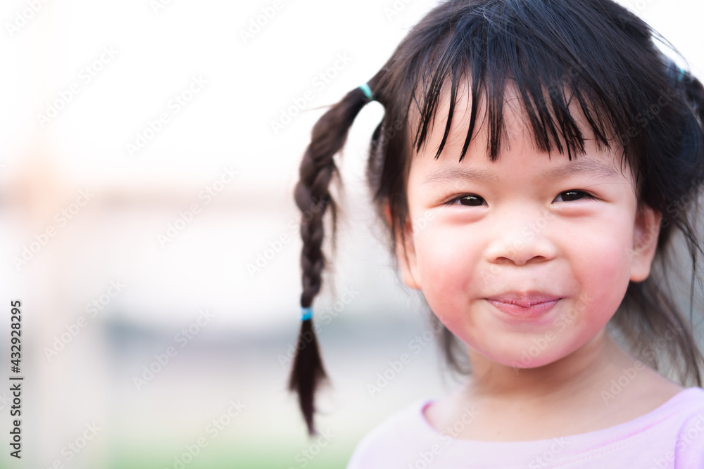 Closeup, cute Asian girl sweet smile. Little kid lips peeled and dehydrated from drinking less water. Child braided pigtails. Baby is 4 years old. Closeup, cute Asian girl sweet smile. Little kid lips peeled and dehydrated from drinking less water. Child braided pigtails. Baby is 4 years old.