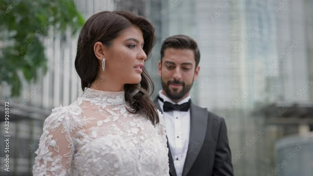 Young Couple On Their Wedding Day. Groom Approaches The Bride. Moment Of Tenderness. Young Couple On Their Wedding Day. Groom Approaches The Bride. Moment Of Tenderness.