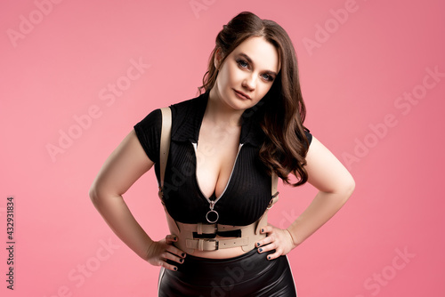 Sexy plus size model with large breasts on pink background