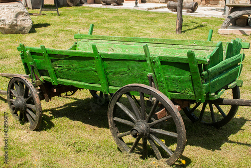 Old green wooden rural cart closeup in village house garden