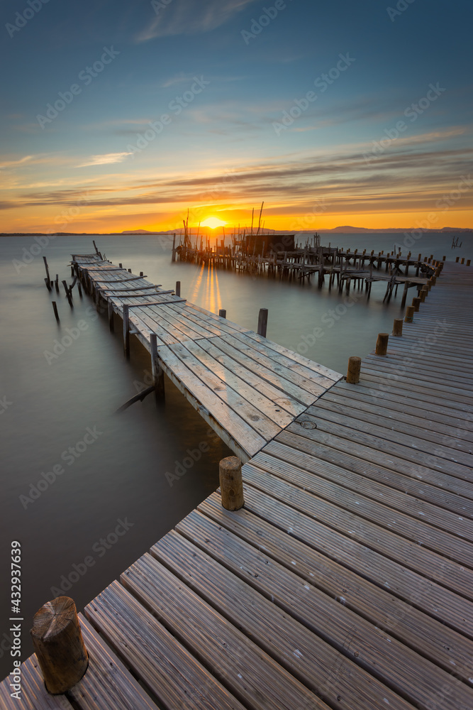 Sunset at Carrasqueira Pier. Located in the small Carrasqueira village in Alentejo, Portugal. His port of artisanal fishing was hand built with wooden pegs.