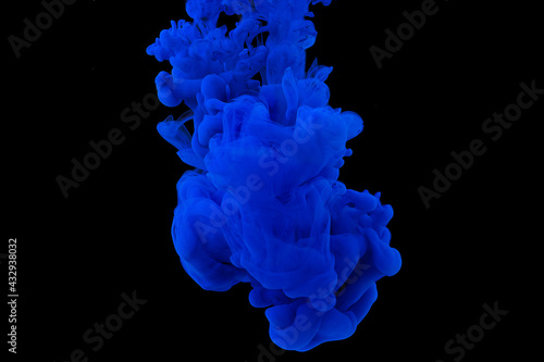 explosion of acrylic blue paint in clear water. Black background
