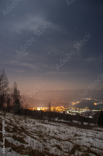 Beautiful panorama of the night city in the mountains in winter