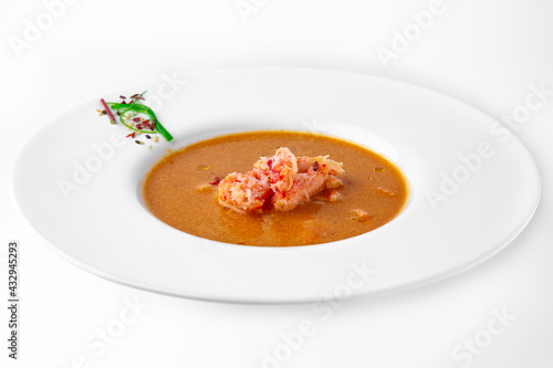 Delicacy spicy cream seafood soup with crab meat. Banquet festive dishes. Gourmet restaurant menu. White background.