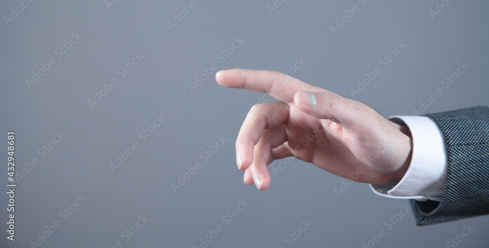 Male hand with finger pointing left direction.