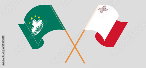 Crossed and waving flags of Macau and Malta