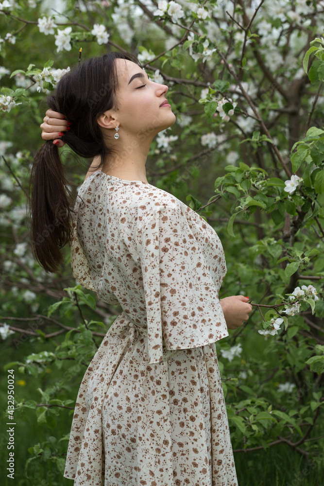 Portrait of a positive cheerful brunette girl in a green spring park. Portrait of a positive cheerful brunette girl in a green spring park.
