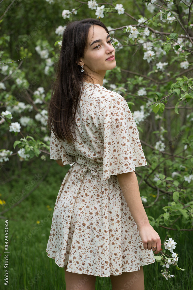 Portrait of a positive cheerful brunette girl in a green spring park. Portrait of a positive cheerful brunette girl in a green spring park.