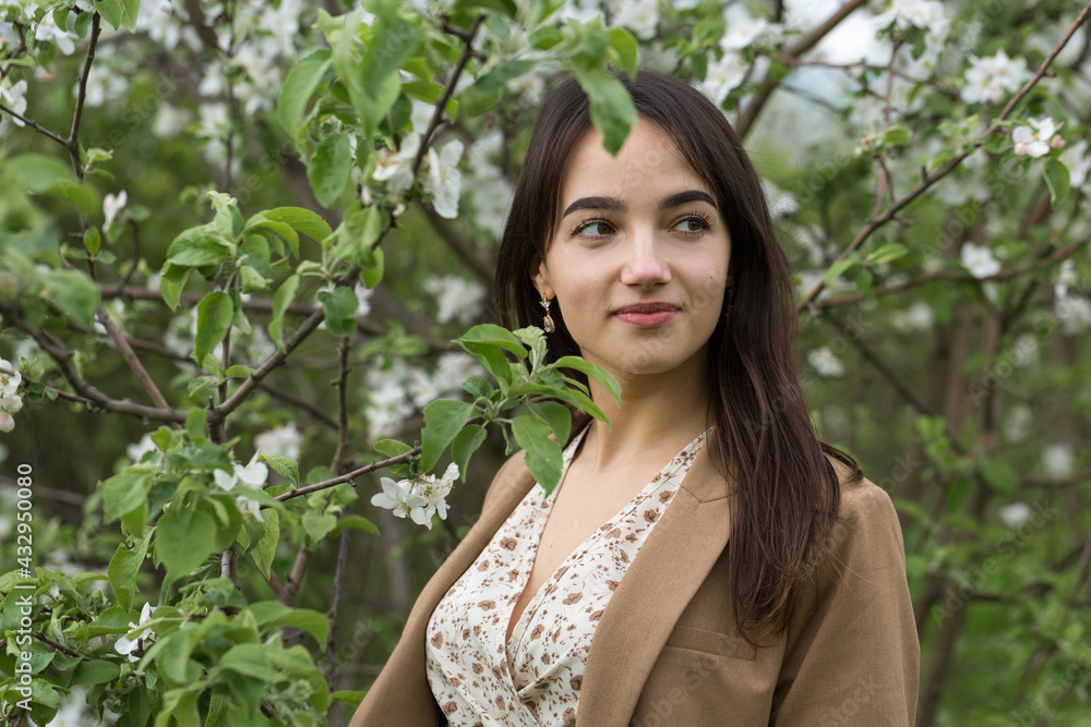 Portrait of a positive cheerful brunette girl in a green spring park. Portrait of a positive cheerful brunette girl in a green spring park.
