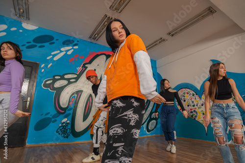 Young dancers in colorful wear having fun dancing hip-hop, enjoy being active. lifestyle, youth generation