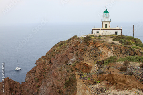 Akrotiri Lighthouse with mist and sea  Santorini  Greece 