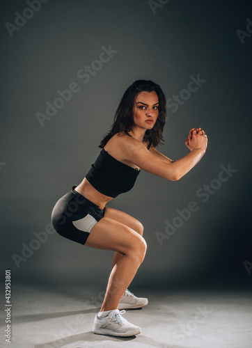 Sporty young woman doing stretching exercise of the muscles