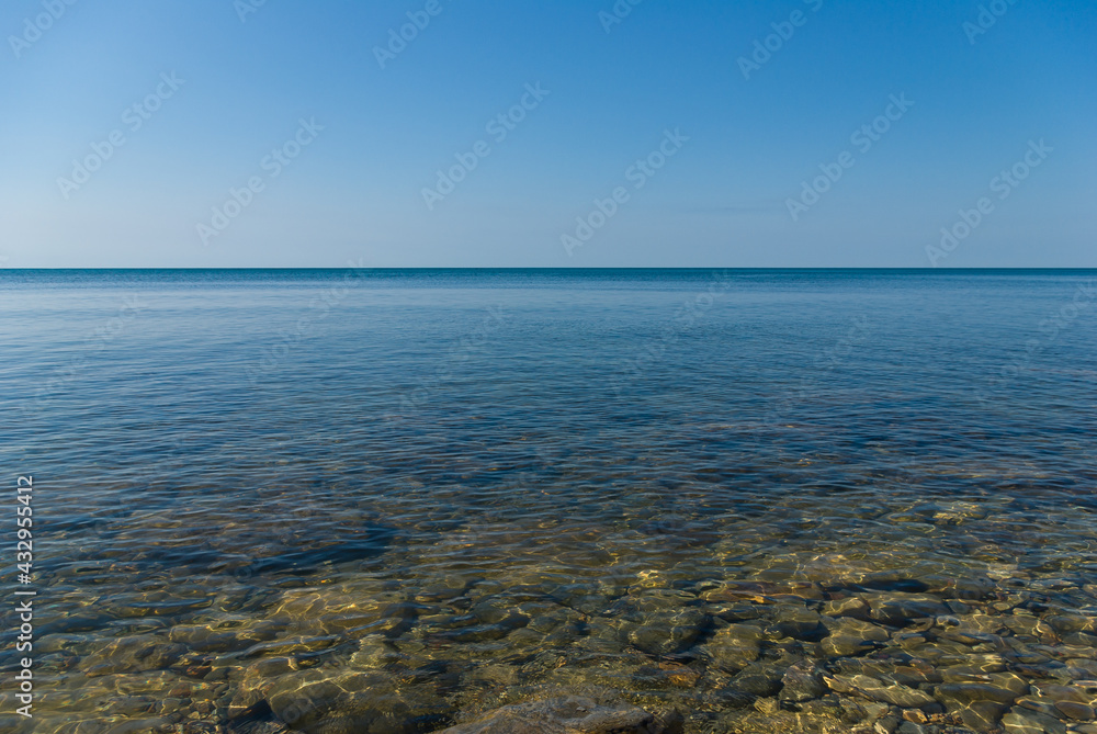 Rocky bottom at the shore of the calm sea