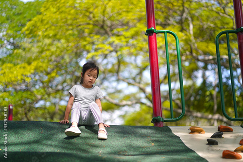 Sad and lonely single child at playground outdoor