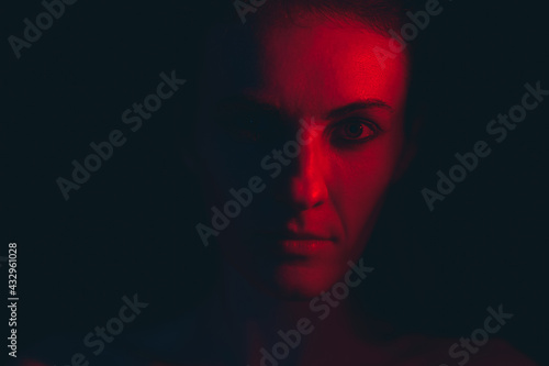 Portrait of a young woman in red light © enginakyurt