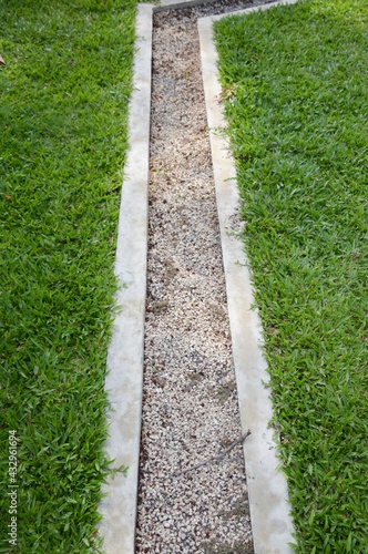 stone on waterway in nature garden