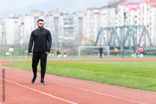 Portrait of Sporty Man on Running Track © Jale Ibrak