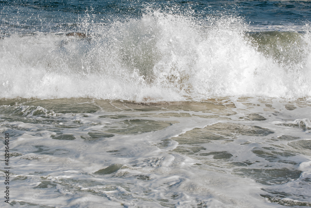 Wave crashes against the rocks of a coast