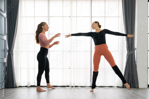 Female ballet teachers training ballerina to have right postures in the private class at home studio. Choreographer teaching caucasian dancers to movements of modern music. Concept of dance rehearsal