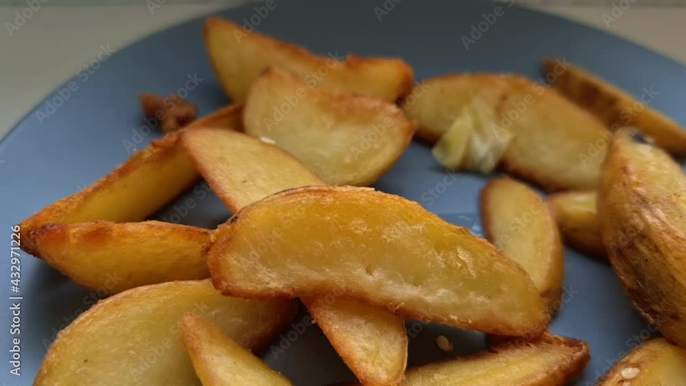 Baked sweet potato wedges . Healthy vegan food concept. Close up. Fried rustic potatoes. Eating baked sweet potatoes. Vegan food concept. Baked sweet potato wedges . Healthy vegan food concept. Close up. Fried rustic potatoes. Eating baked sweet potatoes. Vegan food concept.