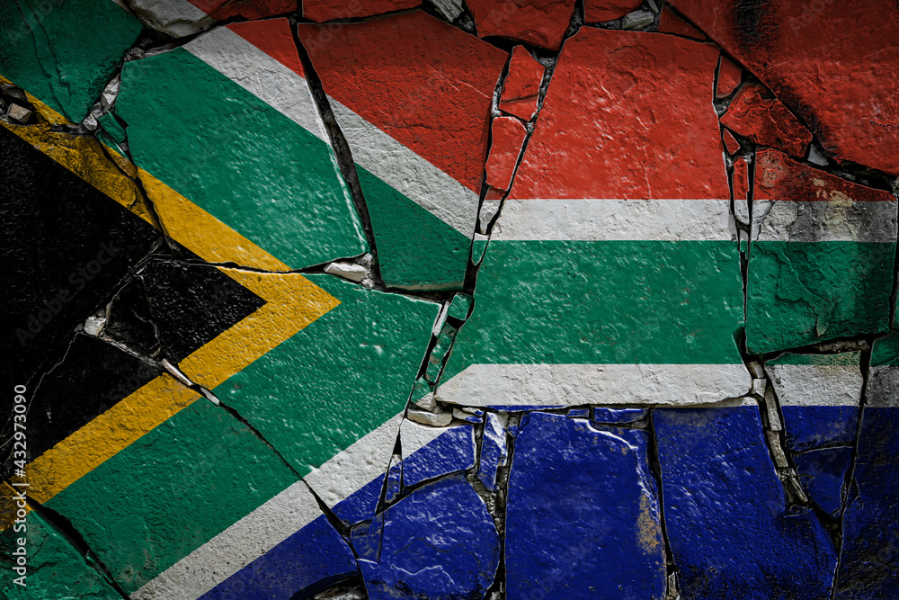 National flag of South African Republic depicting in paint colors on an old stone wall. Flag  banner on broken  wall background.