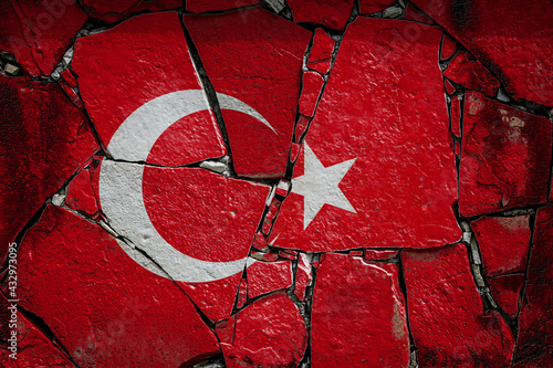 National flag of Turkey depicting in paint colors on an old stone wall. Flag  banner on broken  wall background.