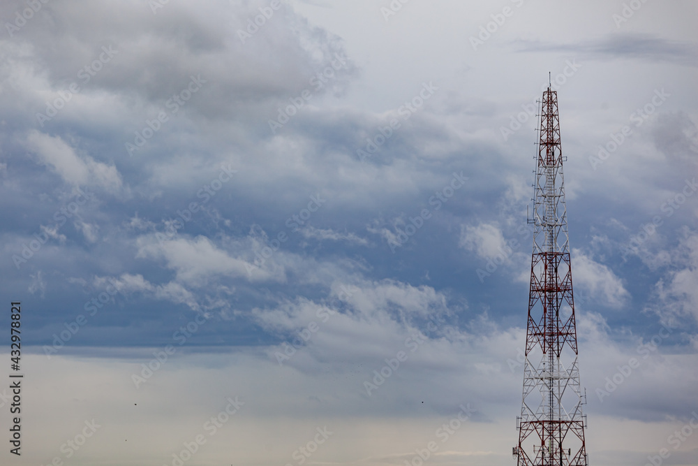 One red and white telephone pole behind the sky. One red and white telephone pole behind the sky.