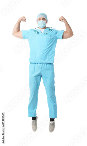 Jumping male doctor on white background