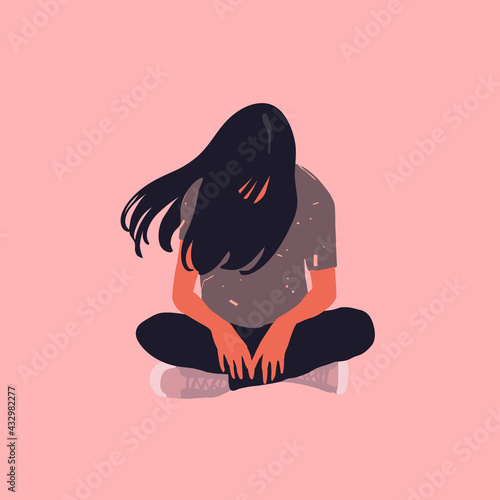 Sad teenager girl sitting on the floor