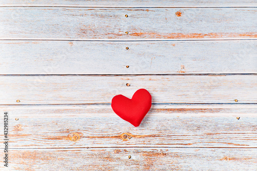 Red heart on a wooden table, health care, donate. world heart day
