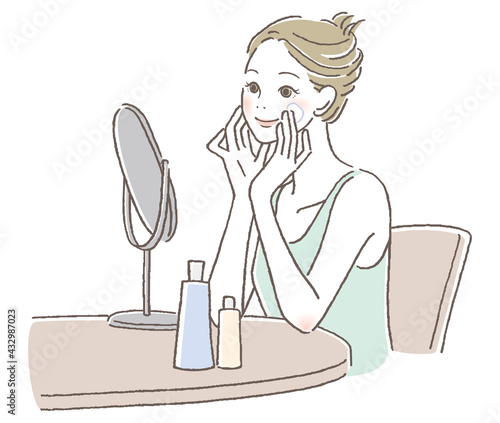 鏡を見て笑顔でスキンケアをしている女性