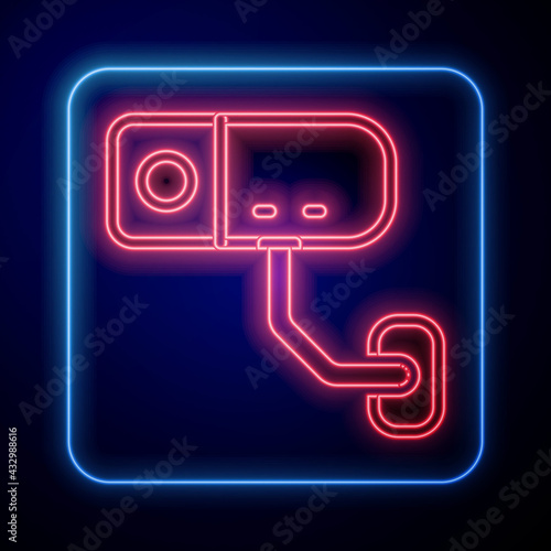 Glowing neon Security camera icon isolated on black background. Vector