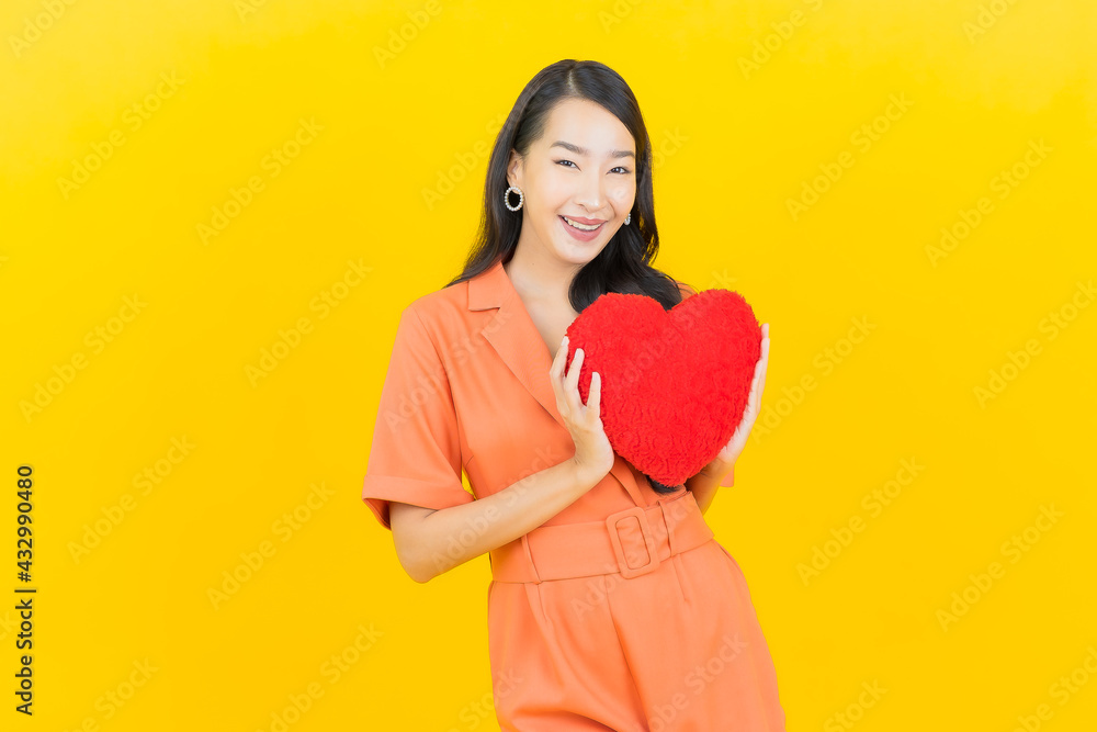 Portrait beautiful young asian woman smile with heart pillow shape Portrait beautiful young asian woman smile with heart pillow shape