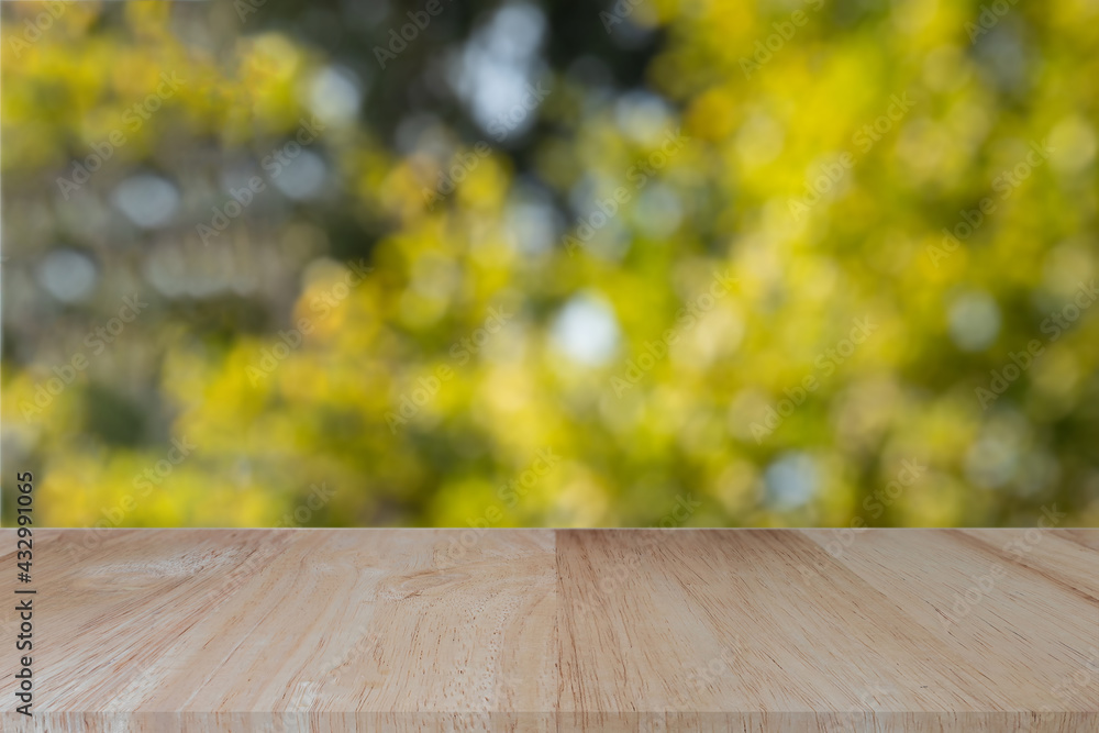 Empty wood table top on blur abstract green bokeh background. For montage product display or design key visual layout. Empty wood table top on blur abstract green bokeh background. For montage product display or design key visual layout.