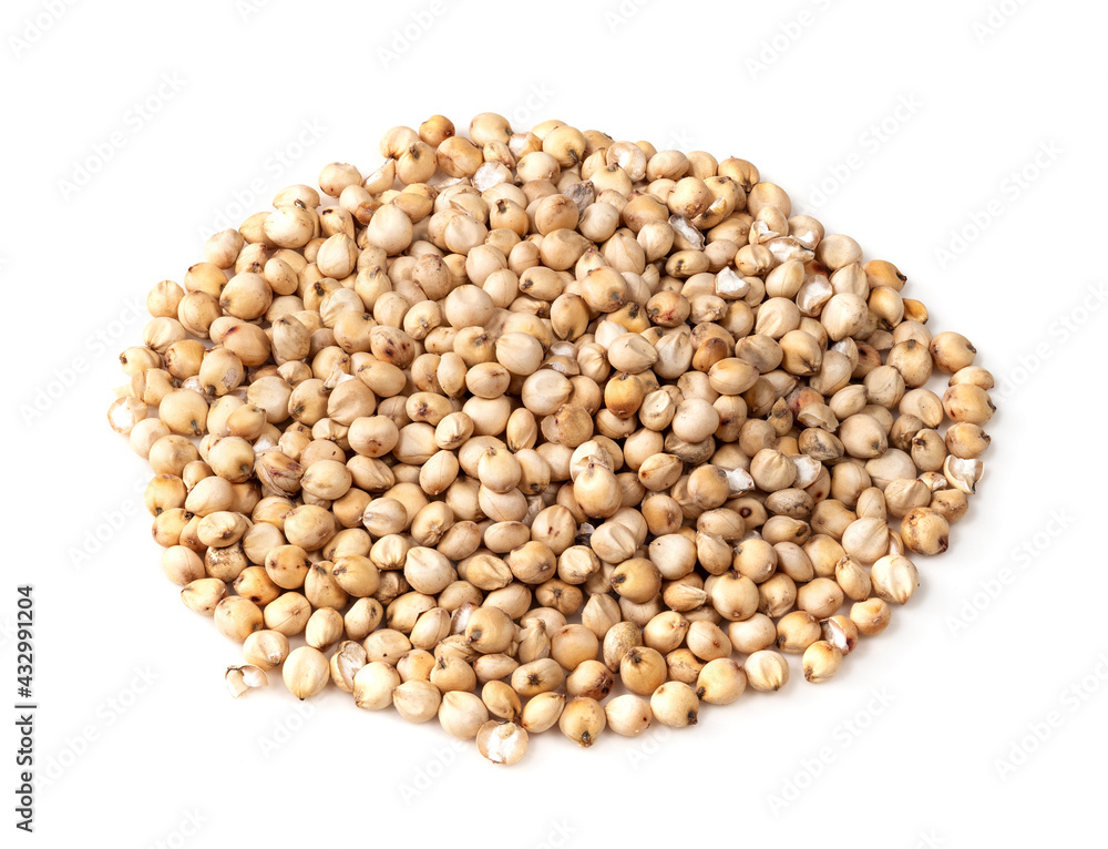 handful of raw unhulled Sorghum grains on white handful of raw unhulled Sorghum grains on white