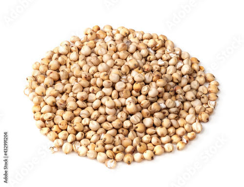 handful of raw unhulled Sorghum grains on white