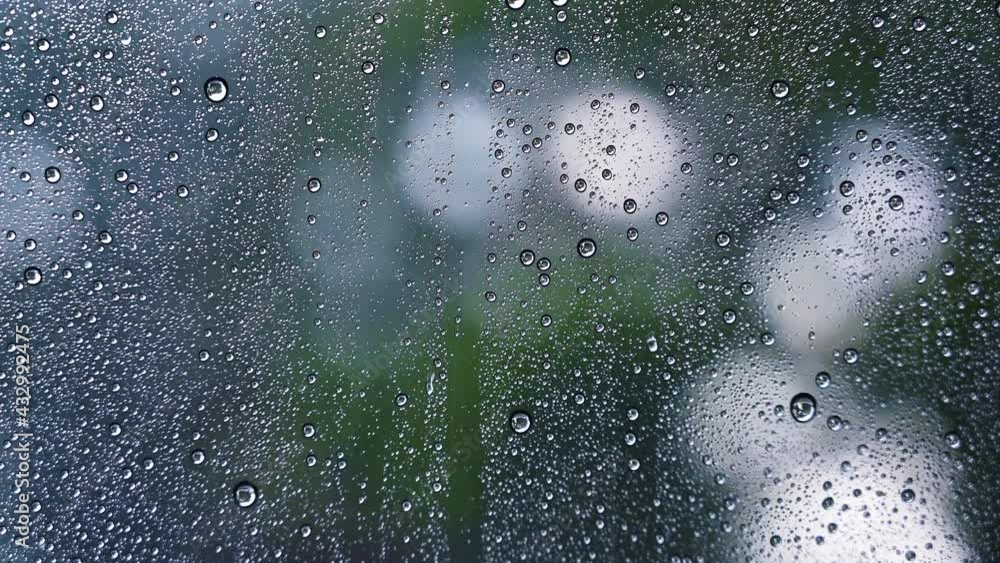 Close up droplets of the rain on window glass on a rainy day. Natural Pattern of raindrops. Close up droplets of the rain on window glass on a rainy day. Natural Pattern of raindrops.