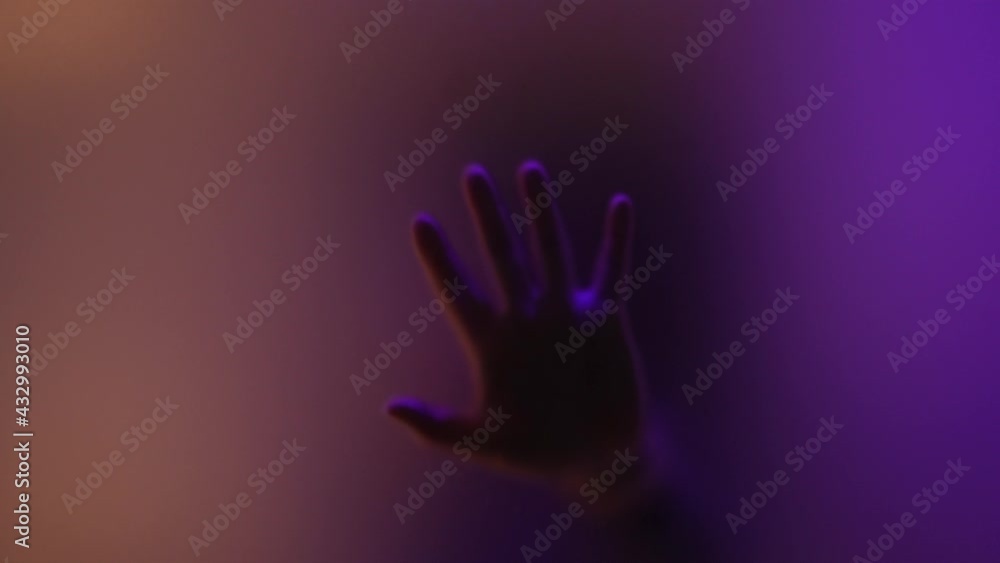 Hand shadow on glass close-up. Black silhouette of man's hand behind glass. Lonely man in closed room. cry for help from lonely locked man. silhouette of black hand outside the window. Fear, horror. Hand shadow on glass close-up. Black silhouette of man's hand behind glass. Lonely man in closed room. cry for help from lonely locked man. silhouette of black hand outside the window. Fear, horror.