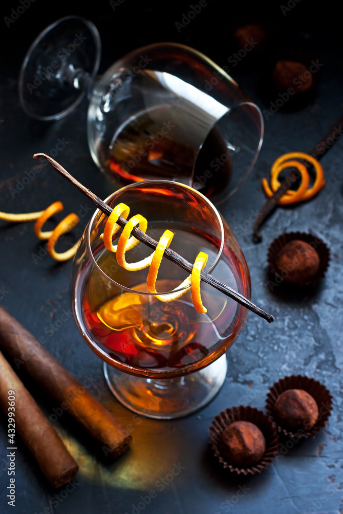 Two glasses of brandy or cognac on  dark table