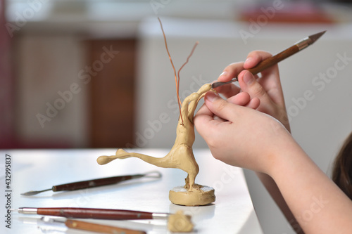 Canvas Print Teenager learning to sculpt figures from plasticine, children's creativity conce