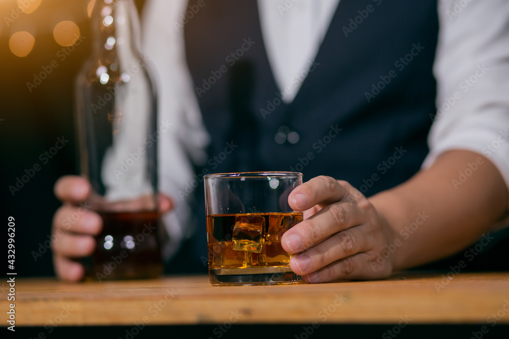 Barman pouring whiskey glass on beautiful bokeh background Barman pouring whiskey glass on beautiful bokeh background