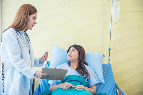 Woman doctor and patient consultation with professional specialist diagnostics at hospital medicare treatment clinic. Doctor writing prescription for medical health care therapy.