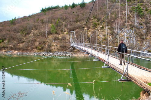 Suspension hanging bridge upon the mountain river Uvac in Uvac canyon of Serbia photo