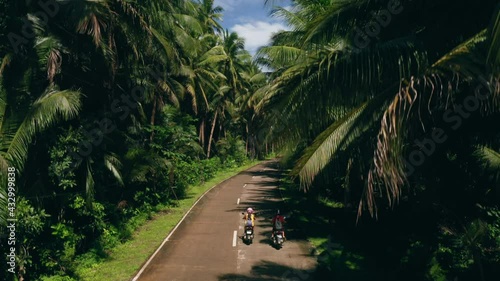 Motorcycles on Road in SIARGAO Revealing Coconut tree and Ocean Landscape 